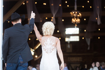 bride and groom walking into reception