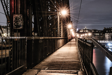 Railway bridge with wooden sidewalk at night