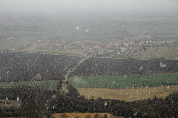 Hazy landscape, snow and rain