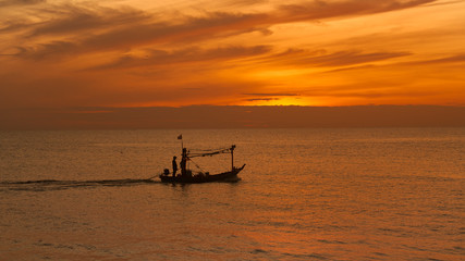 silhouette fisherman boat on seascape with sunrise skyline