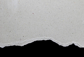Ripped paper on black background, space for advertising copy.