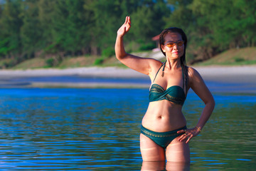 Woman show body with bikin and shadow on beach