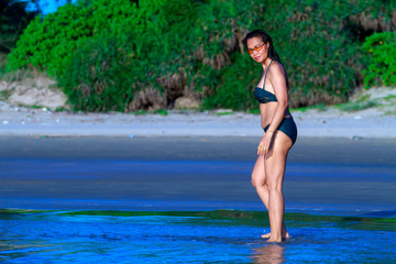 Fototapeta na wymiar Woman with bikini walk and relax on beach