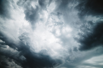 Dramatic cloudscape texture. Dark heavy thunderstorm clouds before rain. Overcast rainy bad weather. Storm warning. Natural gray background of cumulonimbus. Nature backdrop of stormy cloudy sky.