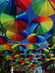 Fototapeta na wymiar Colorful umbrellas background. The sky of colorful umbrellas