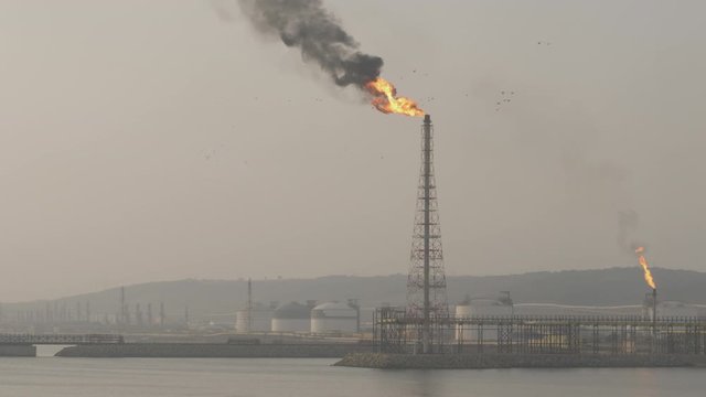 Gas flare of petrochemical refinery in the morning