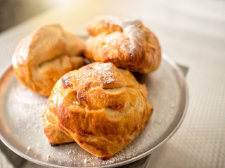 Fresh homemade bread in a metallic plate on whtie table background