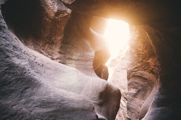 Beautiful shot of the inside of the cave with a light shining from the entrance
