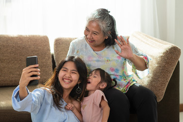 Happy Asian family selfie in their house, love and happiness people concept