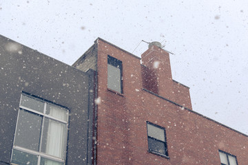 Building facade during very heavy snowfall in Harlem, New York, USA