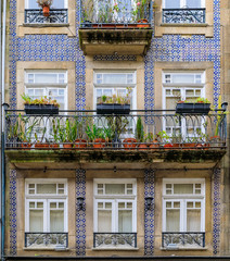 Facades of traditional houses decorated with ornate Portuguese azulejo tiles in Porto, Portugal