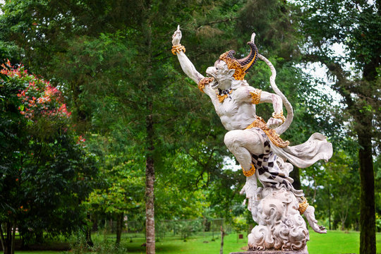 Ancient statue of fighting Hanuman from epic Hindu legend Ramayana in Bedugul botanical garden. Traditional arts, culture of Bali, popular travel destination in Indonesia