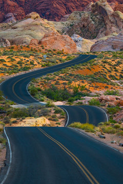 Travel Down A Winding Desert Road Toward Adventure