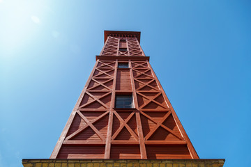 Wooden tower on a background of blue sky