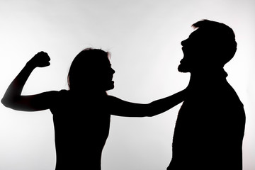 Domestic violence and abuse concept - Silhouette of a woman slapping a man