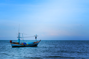 Naklejka na ściany i meble The Old fishing Boat on the sea with lighting