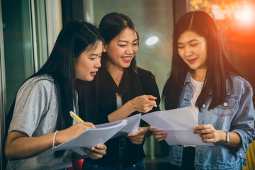 asian younger woman freelance talking with toothy smiling face in home office