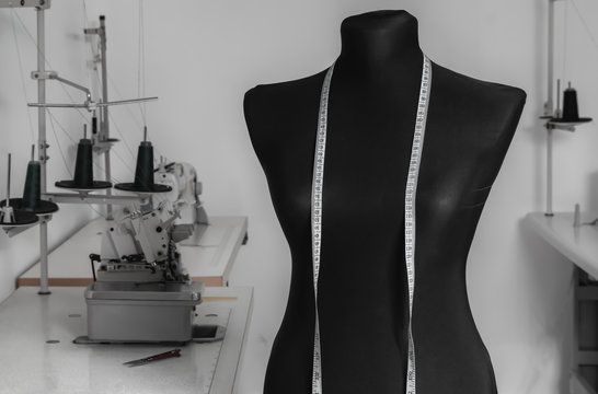 Work dummy on the background of sewing machines in a tailor workshop