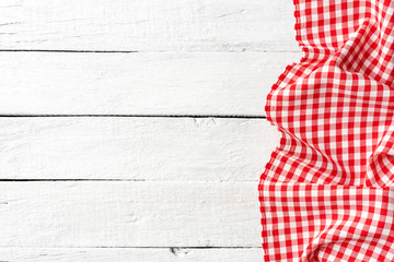 Red gingham tablecloth on white vintage background with copyspace