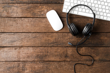 Call center desktop with headphones and computer. Top view