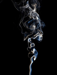 Abstract white smoke swirls on black background