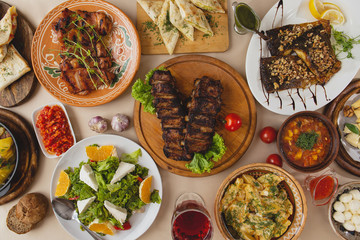 Top view of  big rustic wooden table with many dishes. Enjoying dinner