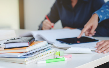 college students classmate doing homework together in library, Selected focus.