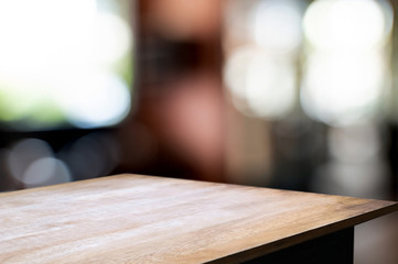 Wooden tabletop in front of montage blur restaurant cafe or kitchen background.