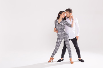 Young love couple dancing social danse kizomba or bachata over white background with copy space