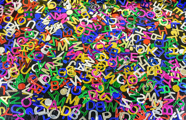 Colored background with random pile of scattered alphabet letters