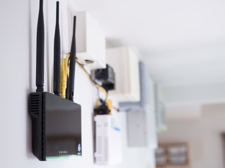 Close up of wireless router on the wall. - obrazy, fototapety, plakaty