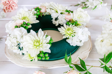 Woman shows how to make wedding table decoration with wreath and candle © agneskantaruk