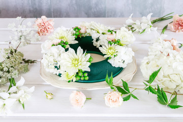 Woman shows how to make wedding table decoration with wreath and candle