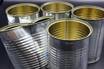 group if empty tin cans on black background isolated