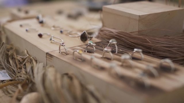 Jewelry on wooden base in slow motion