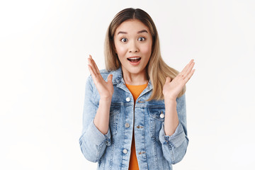 Amused friendly supportive asian blond girl reacting cheerful great news friend telling about...