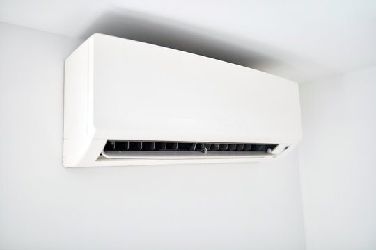 Moder air condition unit on a white wall inside the living room.