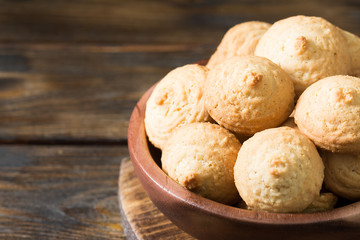 Sesame biscuit in a wooden bowl on a wooden posthole. Rustic style