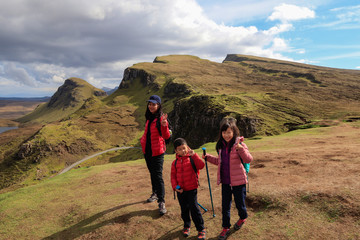 Happy family exploring and hiking scenic mountains