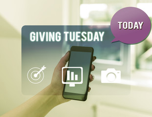 Text sign showing Giving Tuesday. Business photo text international day of charitable giving Hashtag activism woman icons smartphone speech bubble office supplies technological device