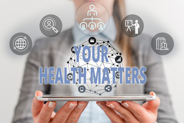 Writing note showing Your Health Matters. Business concept for good health is most important among other things Female human wear formal work suit presenting smart device