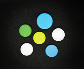 Colorful Plastic bottle caps on black background.