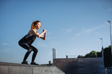 Sporty girl exercises in the morning