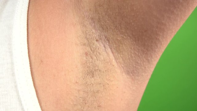 Closeup view of female armpit with hair growing. Modern trand of natural beauty concept. Real time 4k video footage.