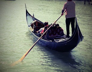 Obraz premium Gondolier in Grand Canal in Venice in Italy with old toned effec