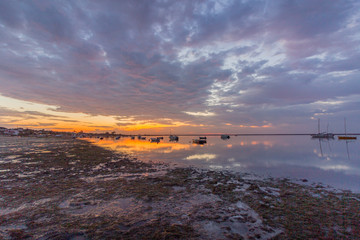 Sunrise cloudy seascape, in Ria Formosa wetlands natural park, shot in Cavacos, Algarve. Portugal.