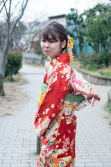 Japanese girl posing for the pictures of the Coming of Age Day. In Japan, people celebrate their 20s of a year as becoming adults wearing Japanese tradition dress.