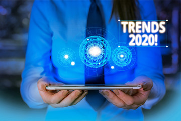 Conceptual hand writing showing Trends 2020. Concept meaning general direction in which something is developing or changing Woman wear work suit presenting presentation smart device