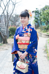 Japanese girl posing for the pictures of the Coming of Age Day. In Japan, people celebrate their 20s of a year as becoming adults wearing Japanese tradition dress.