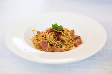 Stir-fried spaghetti spicy bacon, Asian fusion food traditional Thai style.